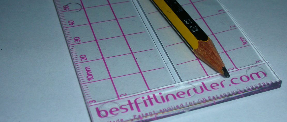 Photo of the Best Fit Line Ruler with a pencil on it