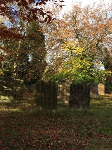 Photo of autumn colours in the graveyard at St Oswald's Church in Durham, England.